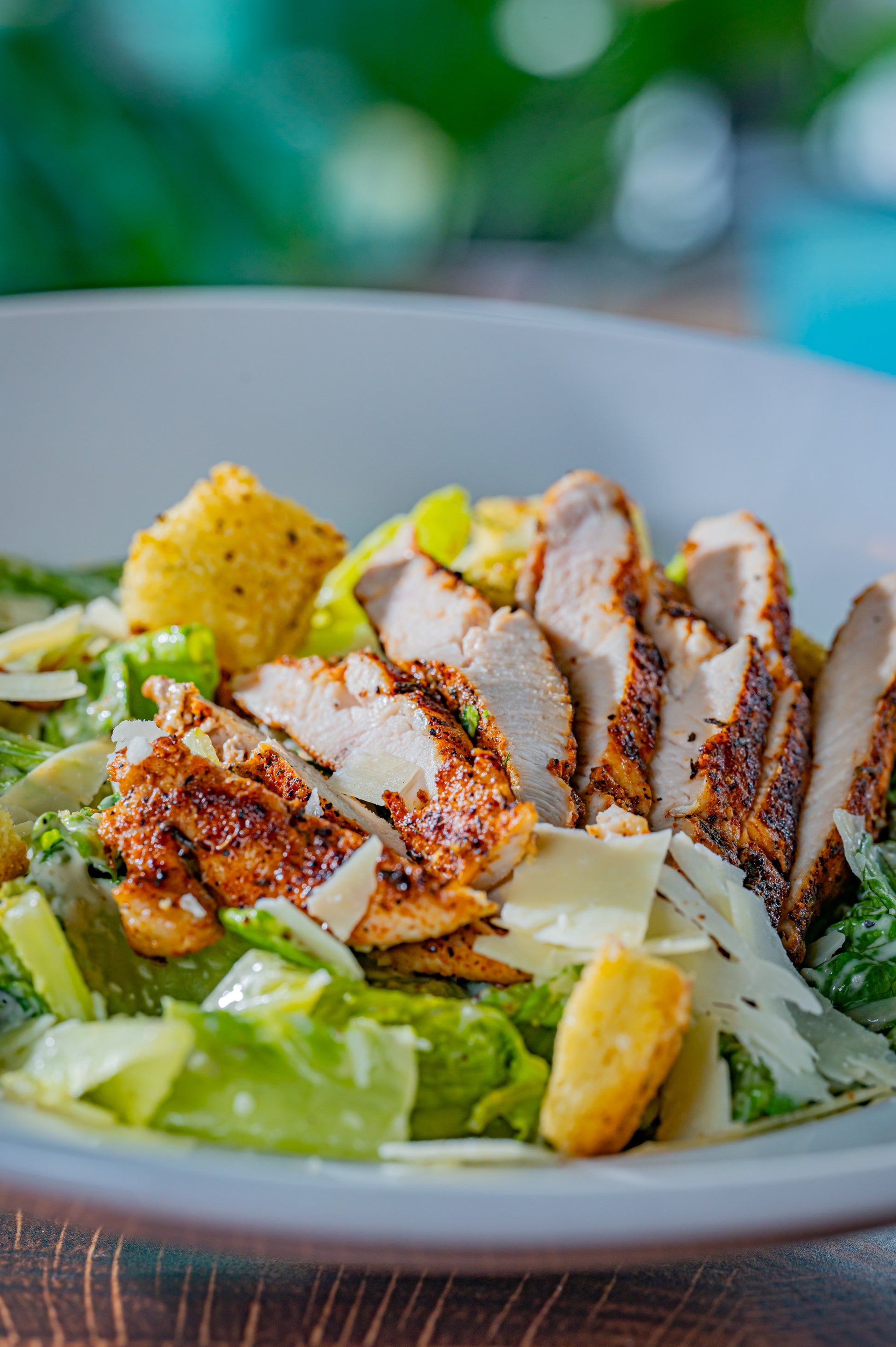 Blackened Grilled Chicken Caesar salad in white bowl