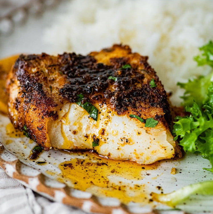 Blackened white fish fillet seasoned with SwissAm Blackened blend, served over rice