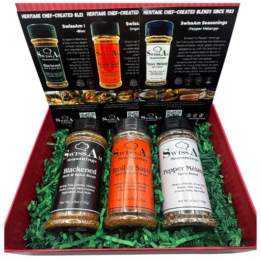SwissAm Seasonings three-shaker gift box featuring Blackened, Broil & Sauté, and Pepper Mélange blends in a red gift box with green crinkle paper.