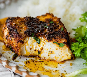 Blackened white fish fillet seasoned with SwissAm Blackened blend, served over rice