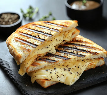 Golden grilled cheese sandwich with melted cheese, seasoned with SwissAm Pepper Mélange.